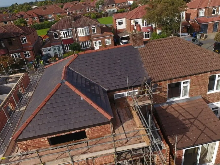 A hipped extension roof finished in dark tiles, seen from above