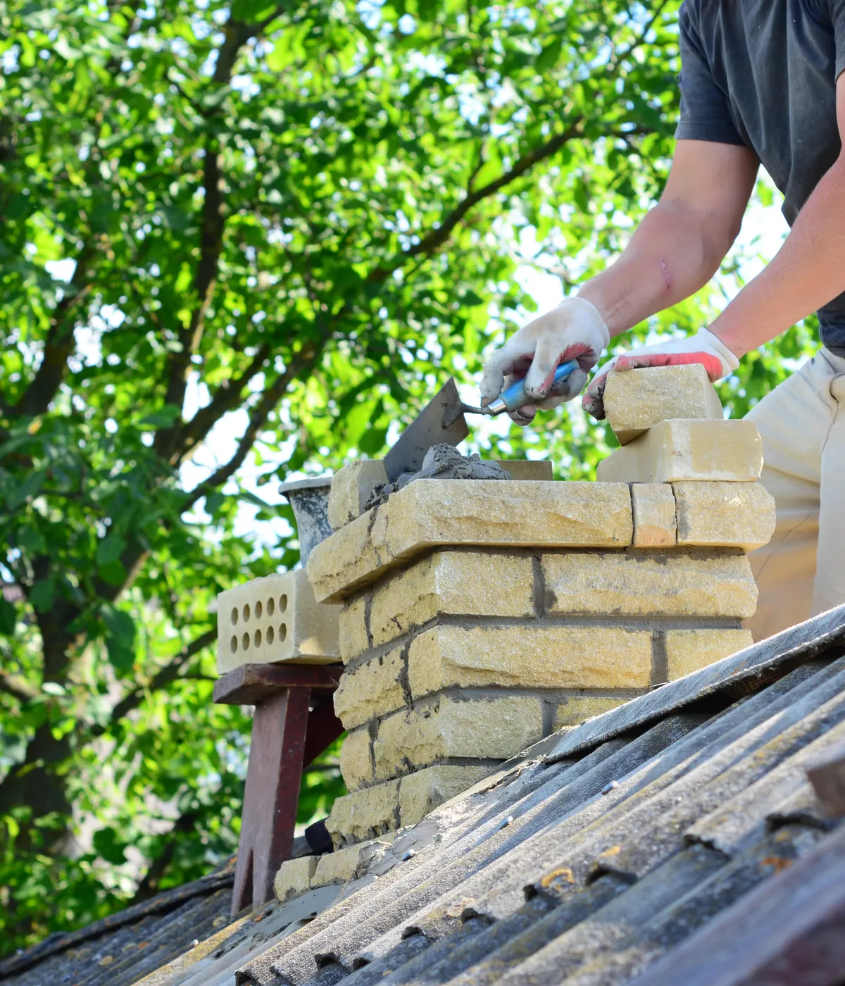 A chimney stack being repointed by hand