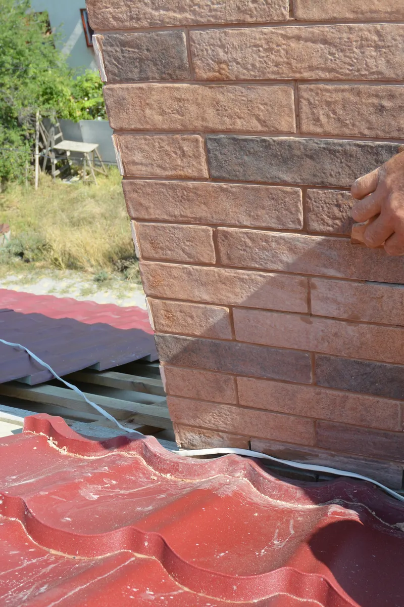 Bricks being laid to rebuild a chimney stack