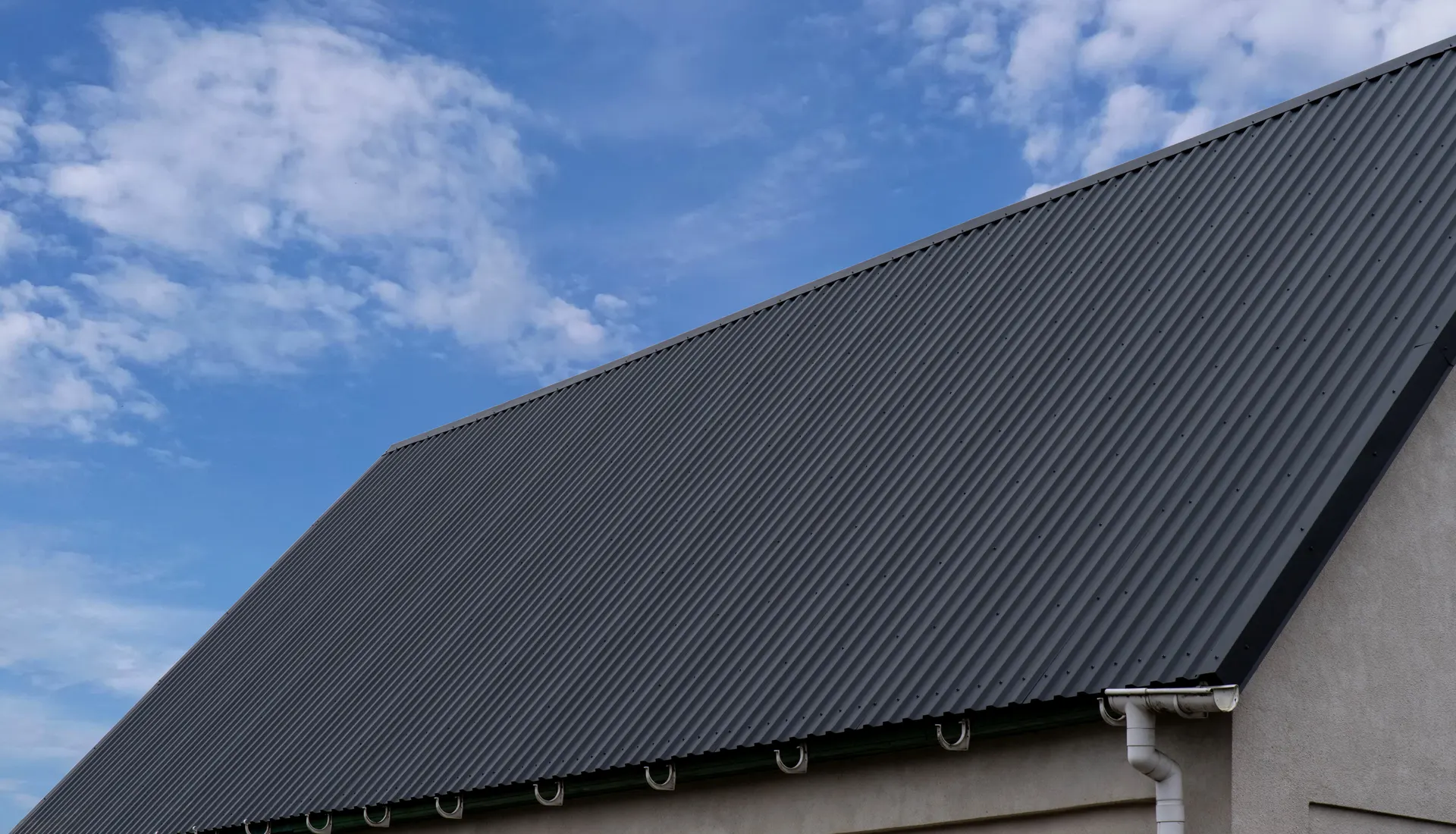 A large building with a dark metal profile roof