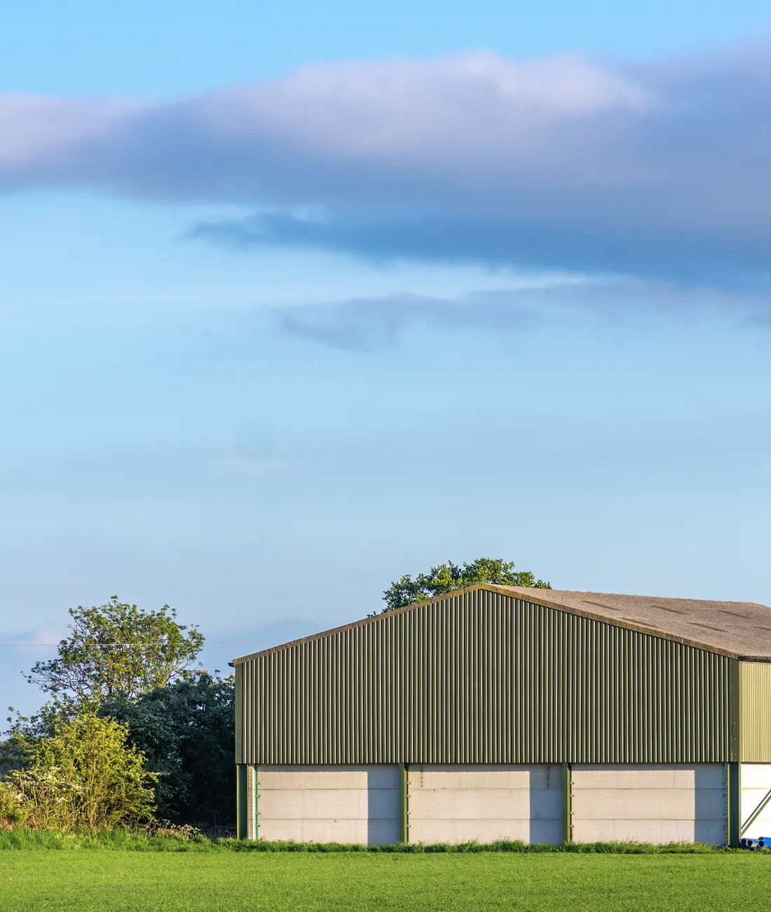 A large farm building with a metal roof