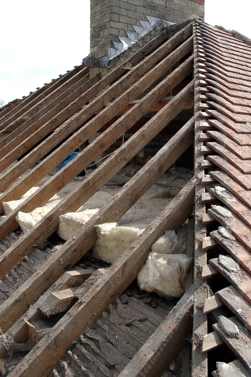 Roof timbers exposed where the tiles have come away