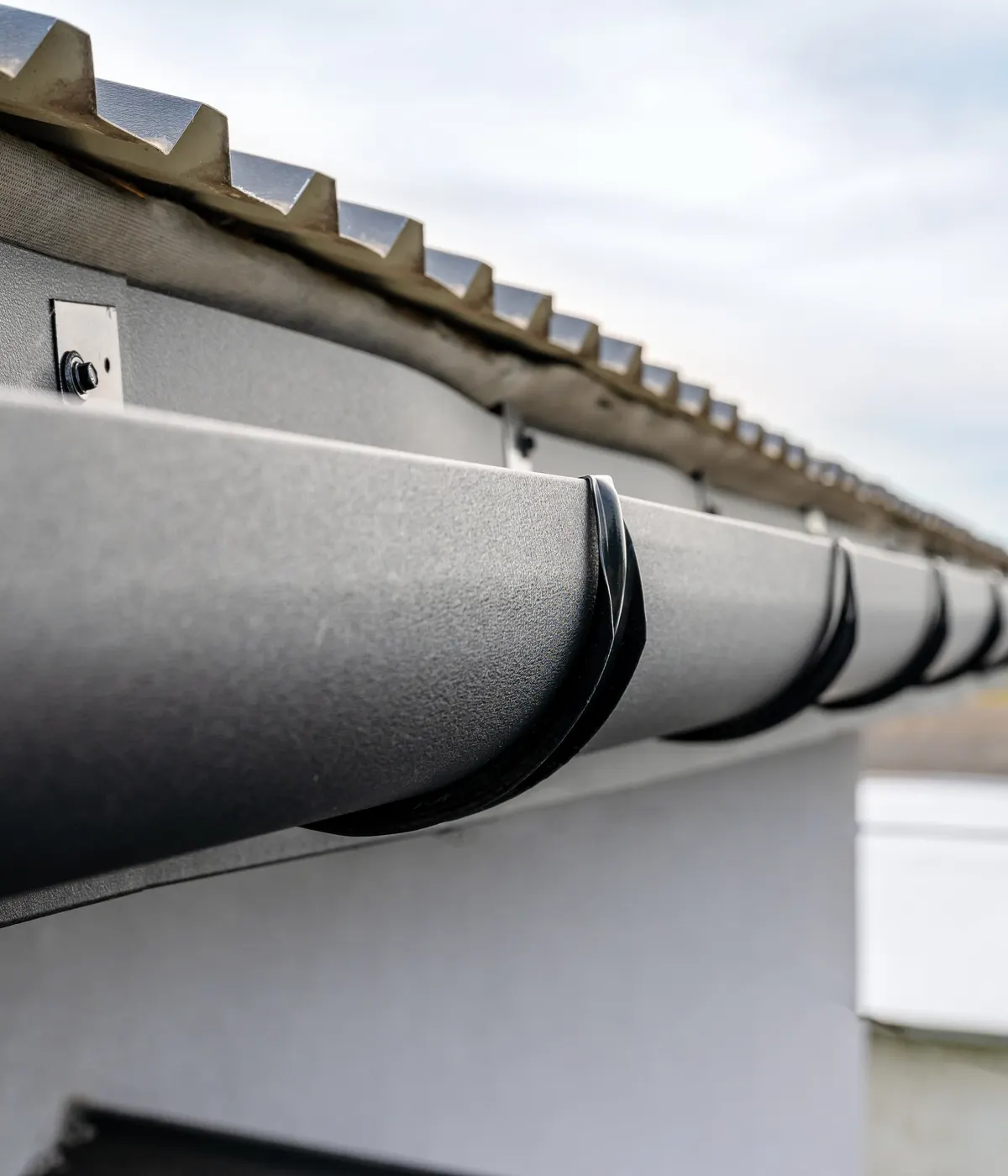 Black half-round guttering on its brackets