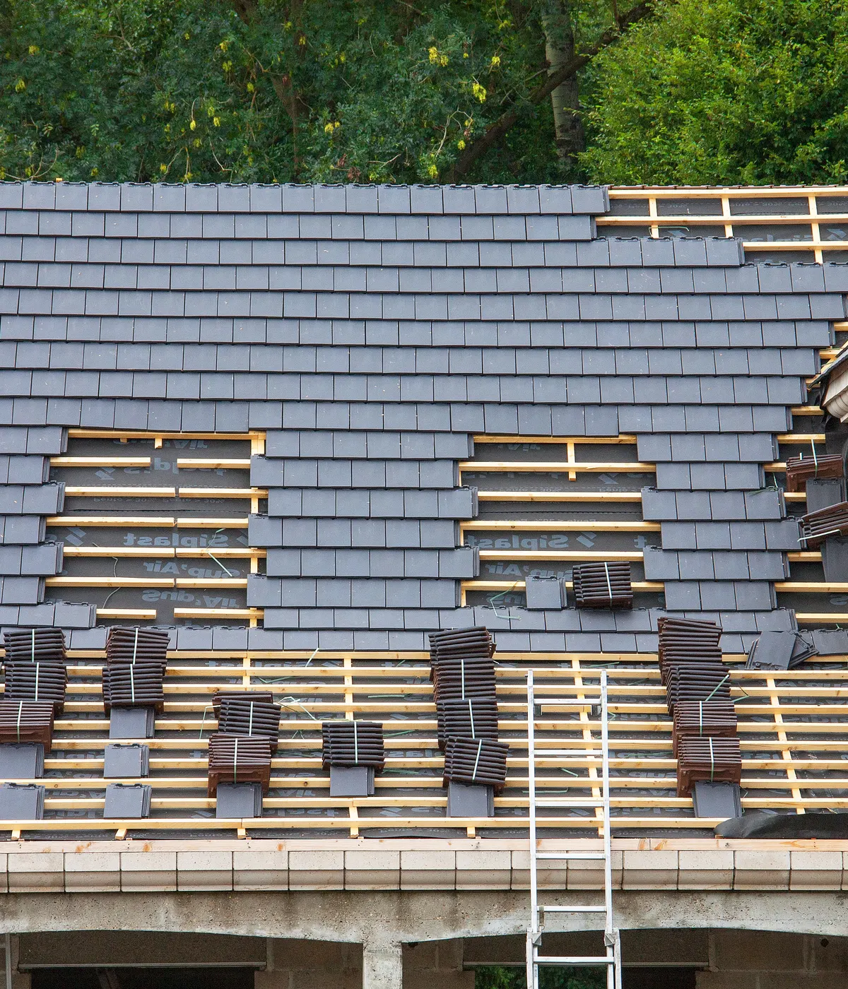 A new tiled roof going on, with the battens still showing near the ridge