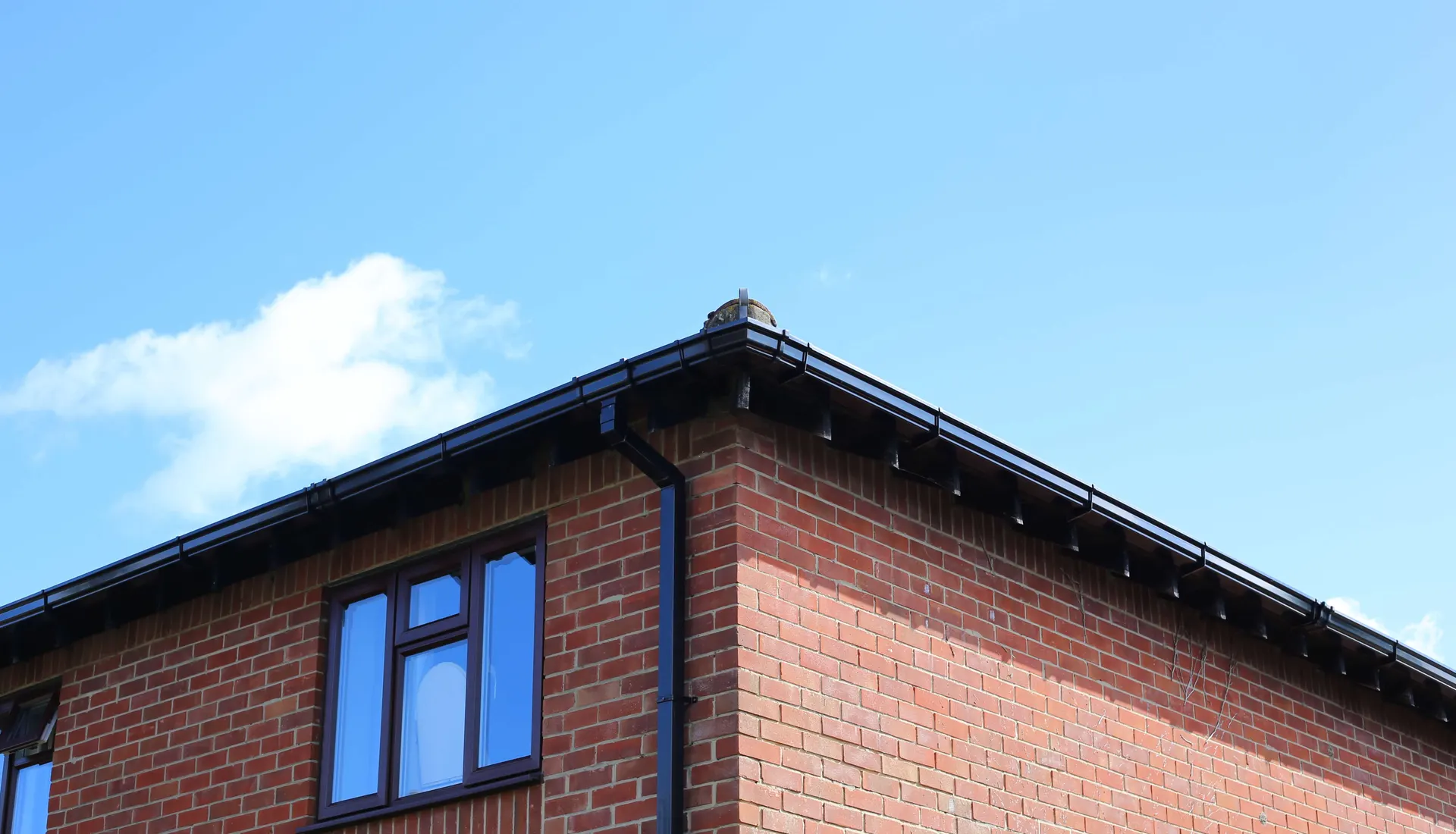 Black fascias, soffits and guttering on a brick house