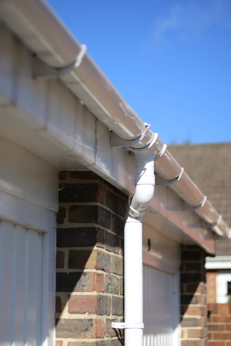 White fascia and guttering along a garage roof