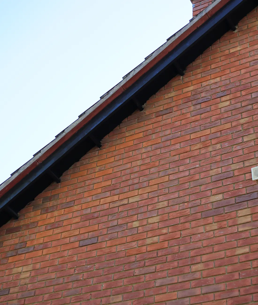 Dark fascia along the gable of a brick house