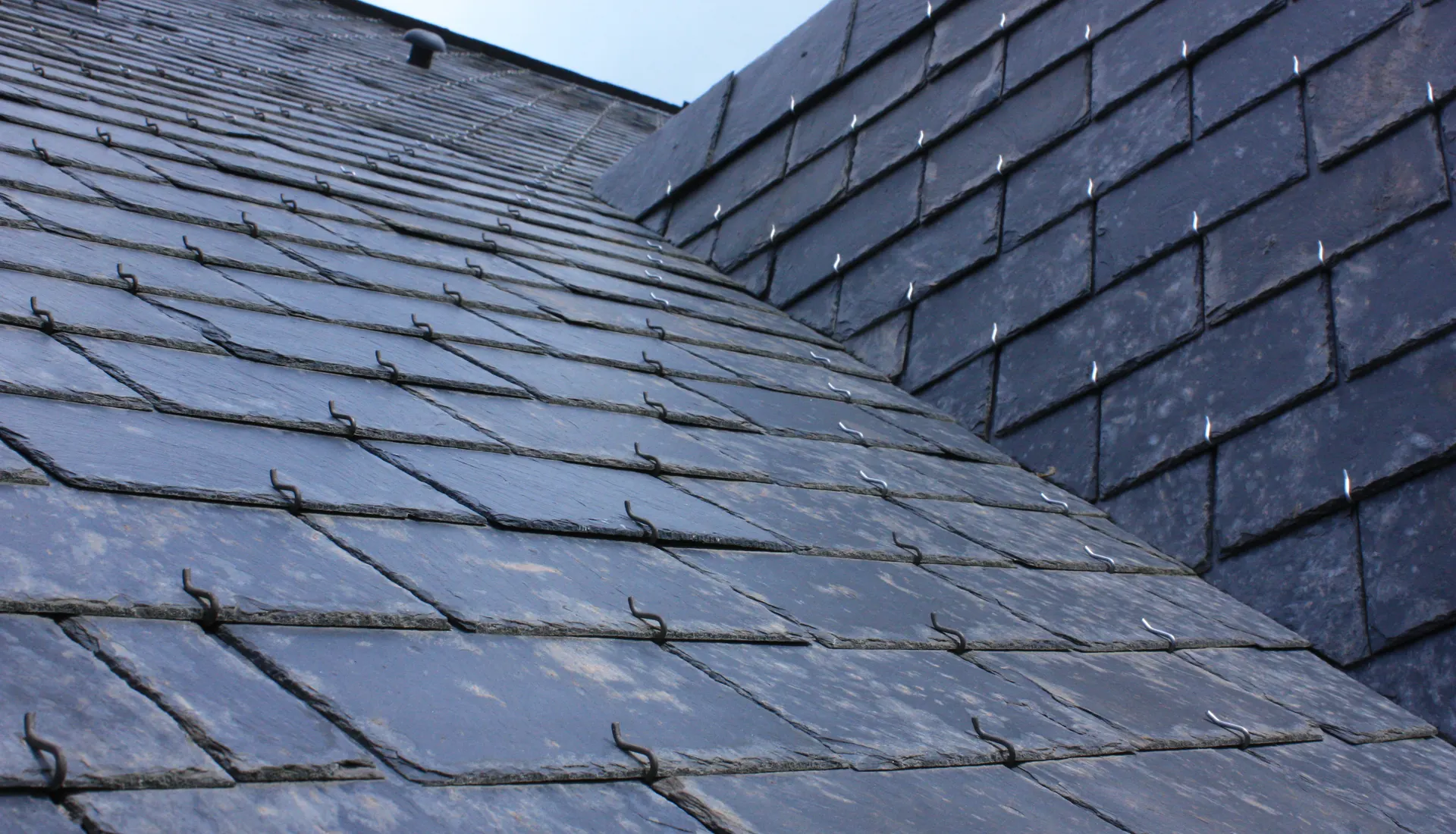 Courses of natural slate meeting at a roof valley