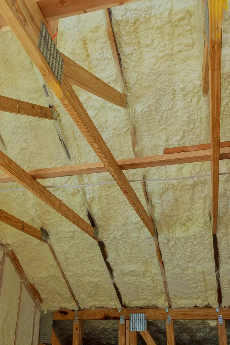 Spray foam between the rafters of a pitched roof